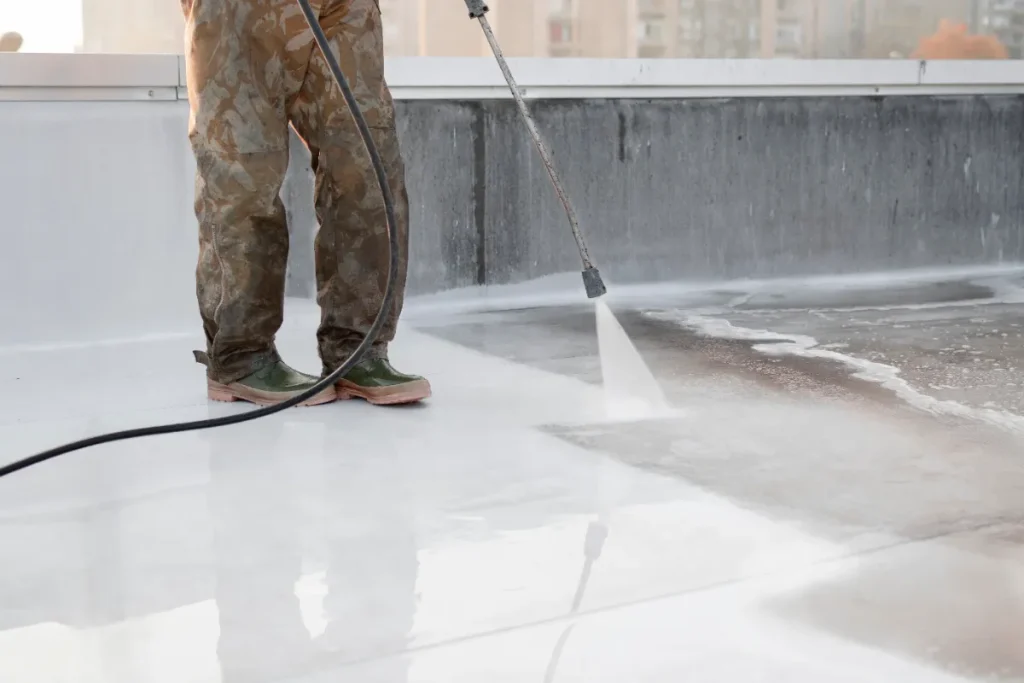 A-person-using-high-pressure-equipment-to-clean-the-bottom-of-a-water-pool.-Cleaning-dirt.-Before-and-after-situation.-Uniform-and-rubber-boots