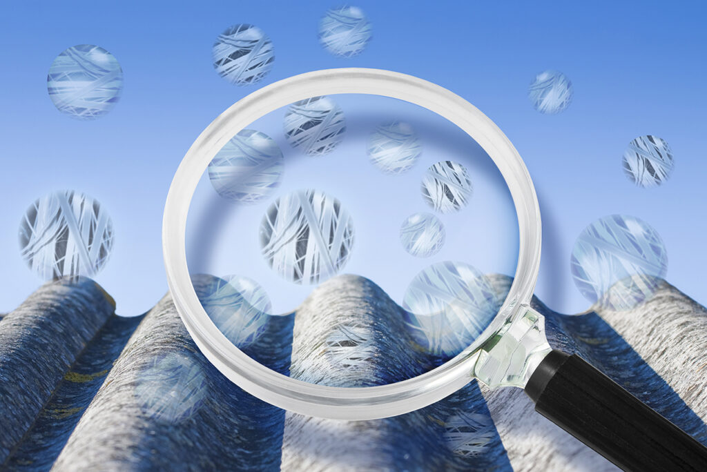 スレート板上を飛散するアスベストを虫眼鏡で確認するイメージ図